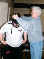 Coach helping player with helmet