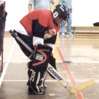 Goalie waiting, two coaches in background
