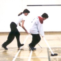 Two athletes competing for puck